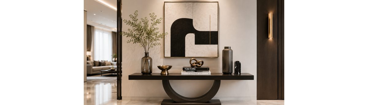 Luxury console table styled with a sculptural vase, books, art object and premium home decor accessories