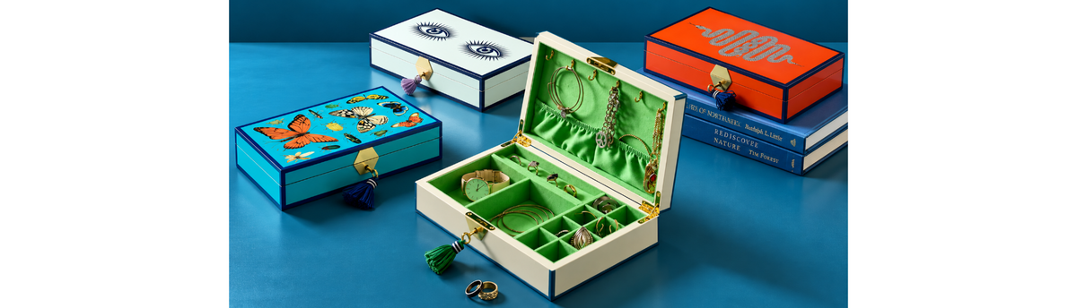 Luxury decorative boxes styled as premium home decor accessories with a blue background.