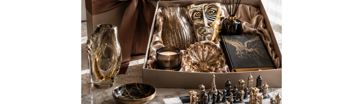 Luxury home decor gift hamper with decorative vase, sculpture, candle, reed diffuser and coffee table book for elegant Indian homes