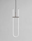 Neon light fixture shaped like a U on a gray background