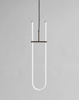 Neon light fixture shaped like a U on a gray background