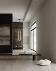 Modern interior with a long vertical light fixture, minimalist decor, and a large window.