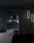 Modern bedroom with dark walls, a bed, and minimal decor.