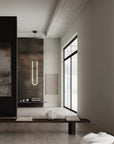 Modern Japandi theme interior with a long vertical light fixture, minimal decor, and a large window.