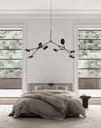 A Wabi Sabi theme bedroom interior with a minimal chandelier hanging from the ceiling.