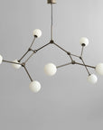 Modern chandelier with white spherical lights on a gray background