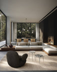 Modern living room with a large sectional sofa, coffee table, and decorative items.
