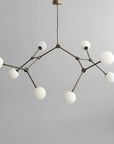Modern chandelier with white spherical lights on a gray background