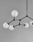Modern chandelier with white spherical lights on a gray background