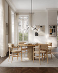 Modern dining room with wooden table and chairs, large windows, and minimal decor.