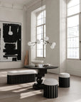 Modern interior with black and white furniture and abstract art.