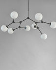 Modern chandelier with white spherical lights on a grey background from 101 Copenhagen available at Spacio retail stores in Mumbai & Kolkat.a