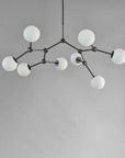 Modern chandelier with white spherical lights on a grey background from 101 Copenhagen available at Spacio retail stores in Mumbai & Kolkat.a