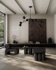 Modern living room with black furniture and chandelier