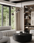 Modern living room with a chandelier, sofa, and coffee table.