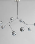 Modern chandelier with multiple spherical lights on a plain background