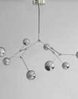 Modern chandelier with multiple spherical lights on a plain background