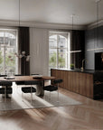 Modern kitchen and dining area with a glass table and black chairs.