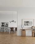 A Scandinavian theme ineriors styled with wall art, sculptural vases , bowl, wall art and a minimal design chandelier.