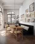 A Scandinavian theme dining room styled with wall art, sculptural vases , bowl and a minimal design chandelier.