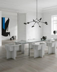 A Scandinavian theme dining room styled with wall art, sculptural vases , bowl, wall art and a minimal design chandelier.
