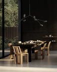 A Scandinavian theme dining room styled with crockery and a minimal design chandelier.