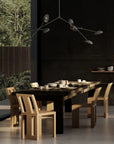 A Scandinavian theme dining room styled with crockery and a minimal design chandelier.
