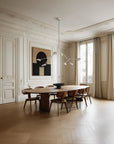 A Scandinavian theme dining room styled with wall art, bowl and a minimal design chandelier.