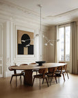 A Scandinavian theme dining room styled with wall art, bowl and a minimal design chandelier.
