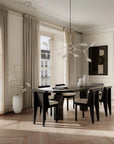 A Scandinavian theme dining room styled with wall art, sculptural vases , bowl and a minimal design chandelier.