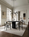 A Scandinavian theme dining room interior styled with a minimal chandelier , vases and wall arts
