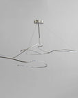 Modern pendant light with wavy design on a gray background
