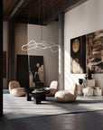Modern living room with abstract art, stylish furniture, and a hanging light fixture.