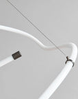 Close-up of a white metal rod with a black connector on a light gray background