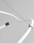 Close-up of a white metal rod with a black connector on a light gray background