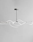Modern pendant light with white curved design on a gray background from 101 Copenhagen available at Spacio retail stores in Mumbai & Kolkata.