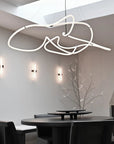 Modern dining room with a unique ceiling light fixture.