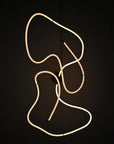 Neon light sculpture on a black background