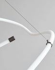Close-up of a white curved tube with connectors on a gray background