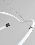 Close-up of a white curved tube with connectors on a gray background