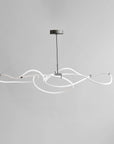 Modern pendant light with white curved arms on a gray background