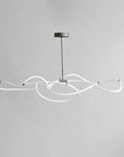 Modern pendant light with white curved arms on a gray background