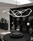 Modern chandelier hanging in a stylish room with bookshelves and decor.
