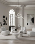 Modern living room with white furniture and abstract art