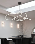 Modern dining room with a unique ceiling light fixture.