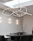 Modern dining room with a unique ceiling light fixture.