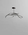 Modern black pendant light on a gray background