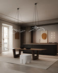 Modern kitchen with stylish chandeliers and a dining table.