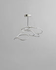Modern pendant light with a silver finish on a gray background