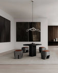 Modern dining room with black table and stools in a minimalistic setting.